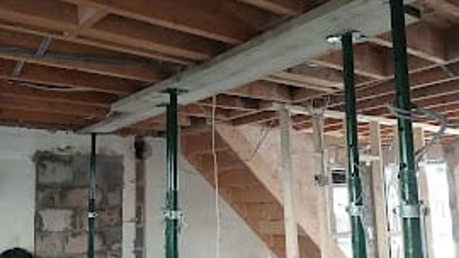 Structural work by Kingdom Build, acrow props supporting the floor above while a steel beam is installed