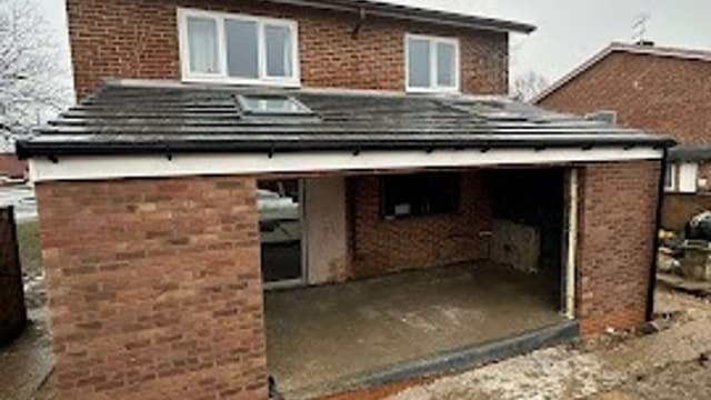 Garage opening being prepared for conversion by Kingdom Build, brickwork in progress