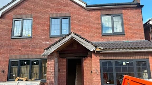 Brick porch with tiled canopy built by Kingdom Build over a front entrance